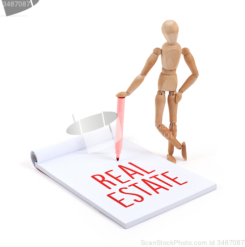 Image of Wooden mannequin writing - Real estate