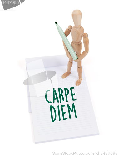 Image of Wooden mannequin writing - Carpe diem