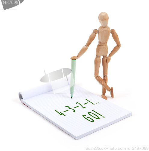 Image of Wooden mannequin writing - Go