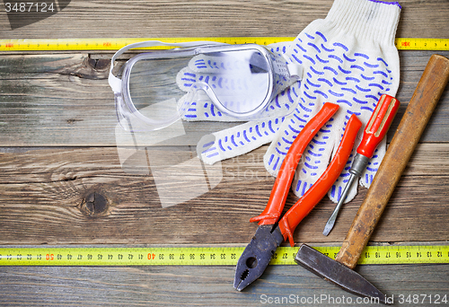 Image of set of the old locksmith tools, safety glasses and work gloves