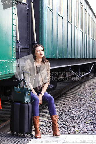 Image of beautiful middle-aged woman traveling in a retro style