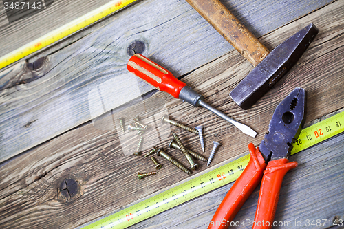 Image of Old hammer, pliers, yellow measuring tape, vintage screwdriver a