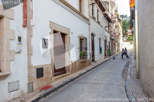 Image of Tossa de Mar, Spain, June 17, 2013: Children play with a ball