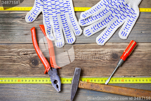 Image of old pliers, hammer and screwdriver