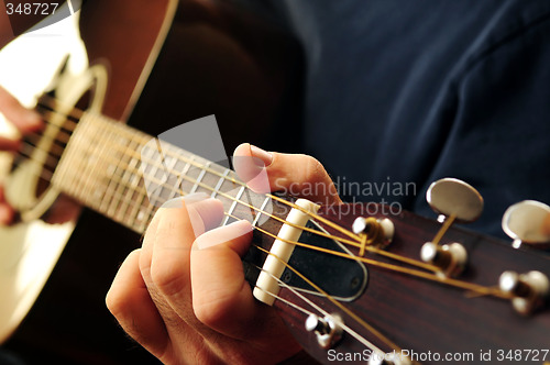 Image of Man playing a guitar