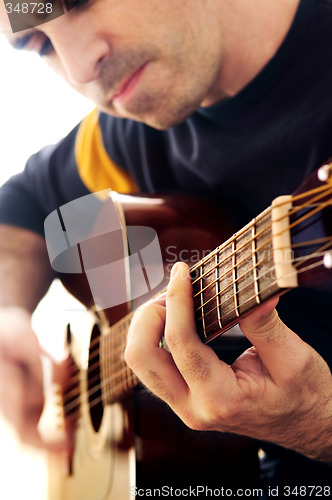 Image of Man playing a guitar