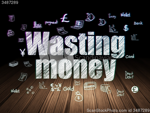 Image of Currency concept: Wasting Money in grunge dark room