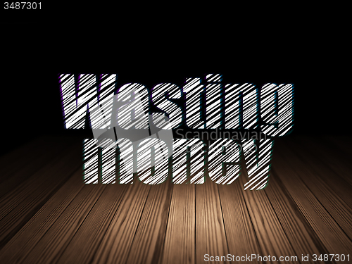 Image of Money concept: Wasting Money in grunge dark room