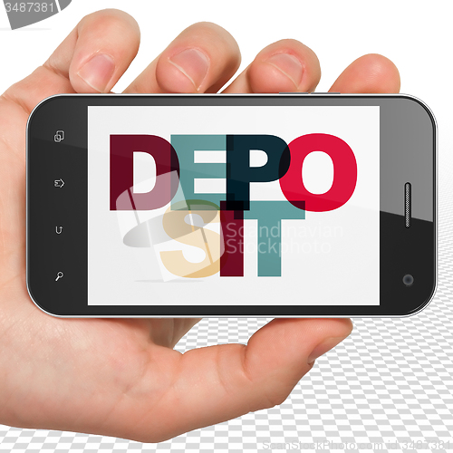Image of Currency concept: Hand Holding Smartphone with Deposit on  display