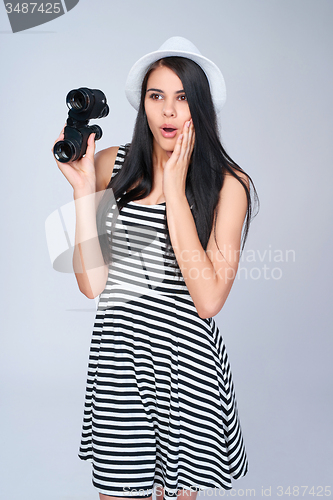 Image of Smiling girl holding binoculars