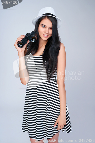 Image of Smiling girl holding binoculars