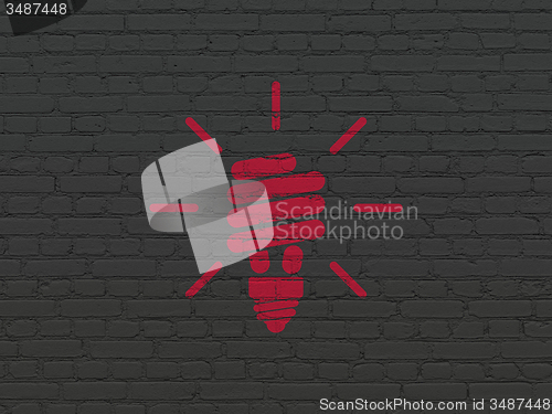 Image of Business concept: Energy Saving Lamp on wall background