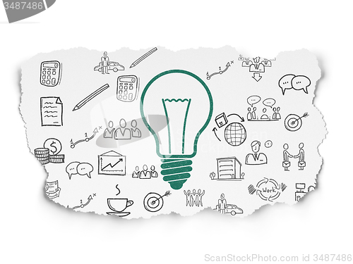 Image of Finance concept: Light Bulb on Torn Paper background