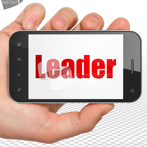 Image of Business concept: Hand Holding Smartphone with Leader on display