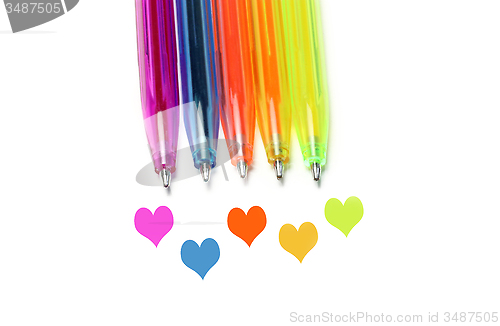 Image of Bright colorful pens and abstract hearts 