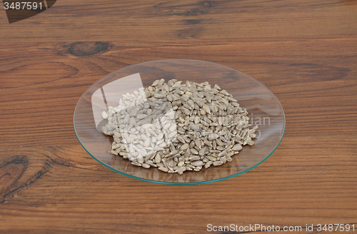 Image of Plate of glass with sunflower nuts