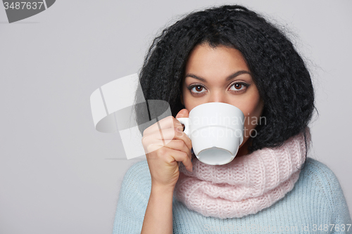 Image of Smiling winter woman with cup of coffee