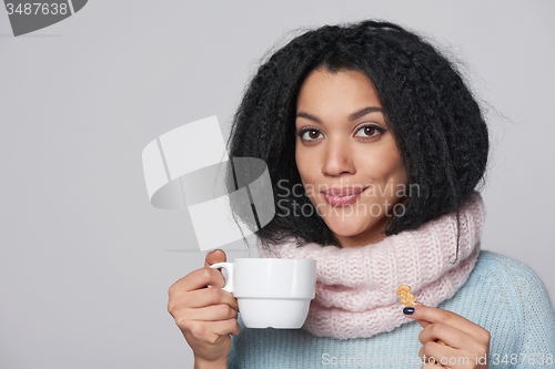 Image of Smiling winter woman with cup of coffee