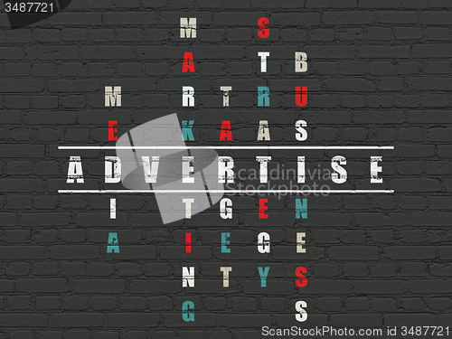 Image of Marketing concept: word Advertise in solving Crossword Puzzle