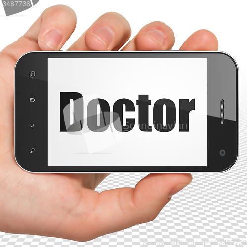 Image of Healthcare concept: Hand Holding Smartphone with Doctor on display