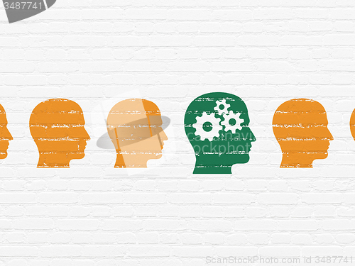 Image of Learning concept: head with gears icon on wall background