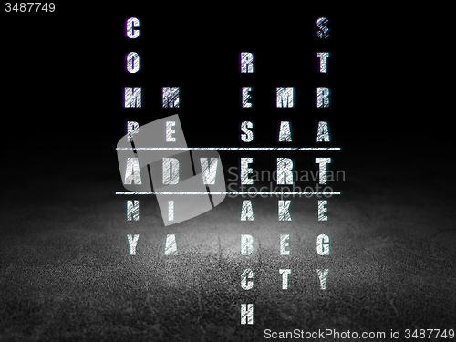 Image of Advertising concept: word Advert in solving Crossword Puzzle