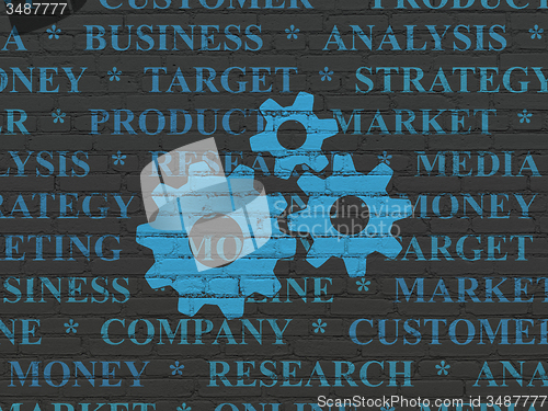Image of Advertising concept: Gears on wall background