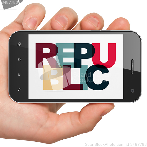 Image of Political concept: Hand Holding Smartphone with Republic on  display