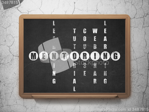 Image of Education concept: word Mentoring in solving Crossword Puzzle
