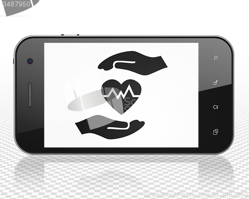 Image of Insurance concept: Smartphone with Heart And Palm on display