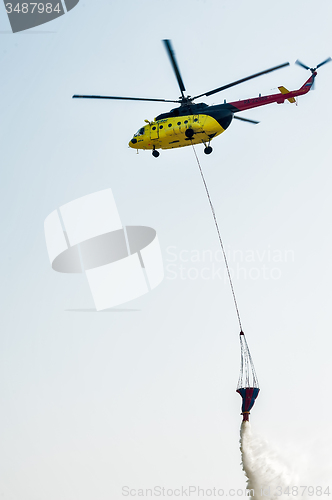 Image of Fire rescue helicopter MI-8 wth water bucket 