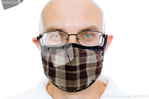 Image of Bald man on a white background in the warm medical mask
