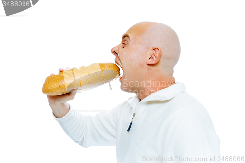 Image of man biting a loaf. Isolated on white. Profile