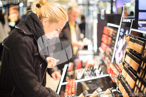 Image of Beautiful woman shopping in beauty store.