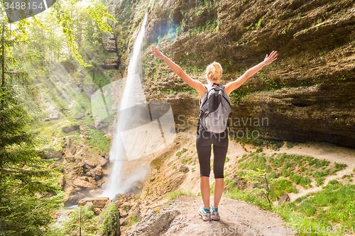 Image of Active sporty woman relaxing in beautiful nature.