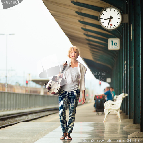 Image of Lady waiting at the railway station.