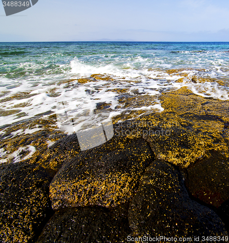 Image of beach  light  water  foam rock spain   sky cloud beach  