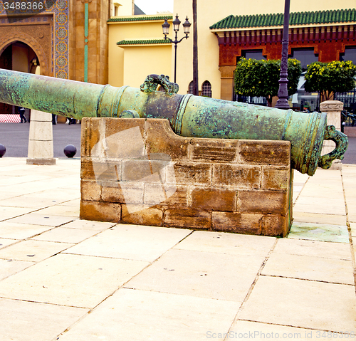 Image of bronze cannon in africa morocco  green  and the old pavement