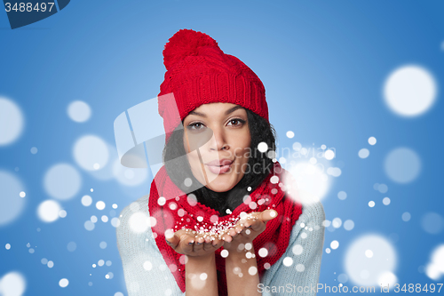 Image of Winter girl blowing snow at you