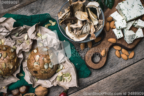 Image of Autumn harvest nuts mushrooms cheese and bread buns 