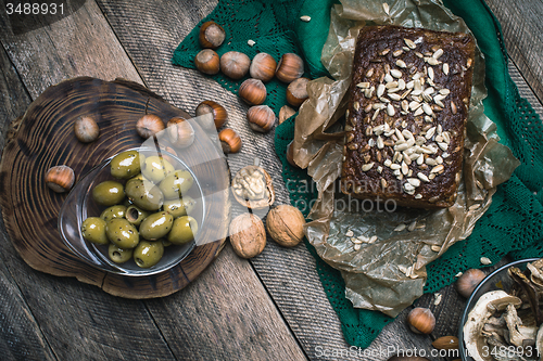 Image of Green olives, nuts mushrooms  and bread with seeds