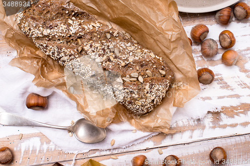 Image of Bread with seeds huzelnuts on wooden board