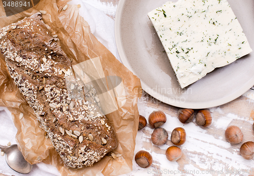 Image of Bread with cheese and huzelnuts for breakfast on board