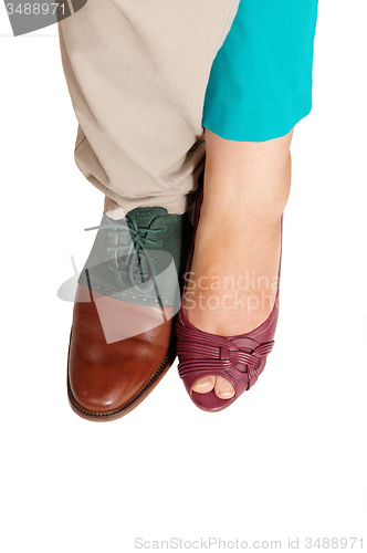 Image of The feet and shoes of a man and woman.