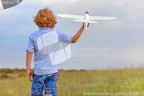 Image of Boy with toy plane
