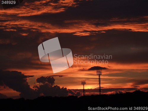 Image of Spotlights in a sports arena in the sunset