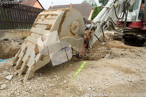 Image of excavator ploughshare on trench - constructing canalization