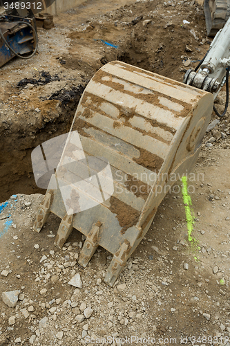 Image of excavator ploughshare on trench - constructing canalization