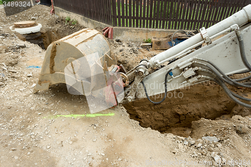 Image of excavator ploughshare on trench - constructing canalization