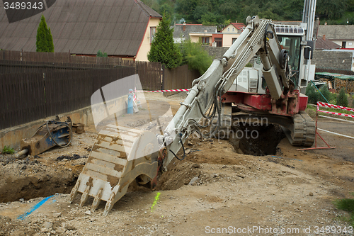 Image of excavator ploughshare on trench - constructing canalization